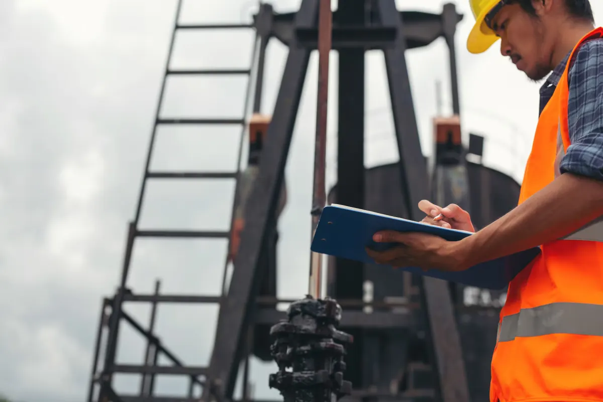 Worker documenting an incident on an industrial site